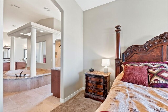 bedroom featuring decorative columns, visible vents, connected bathroom, a sink, and baseboards