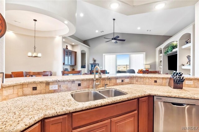 kitchen featuring pendant lighting, brown cabinets, a sink, and stainless steel dishwasher