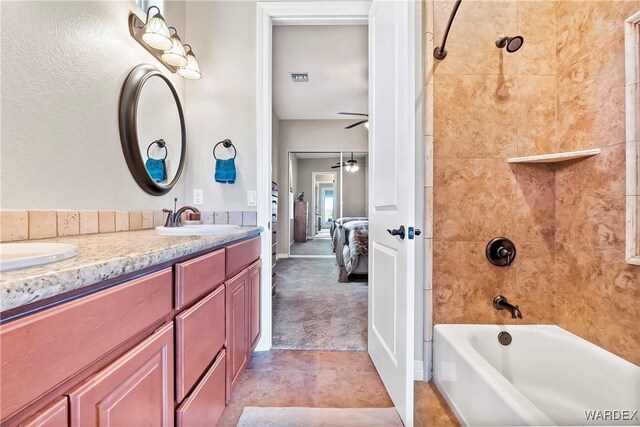 ensuite bathroom with ensuite bathroom, a sink, visible vents, tub / shower combination, and double vanity