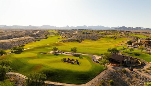 drone / aerial view with view of golf course and a mountain view