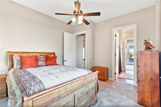 bedroom featuring a ceiling fan and light colored carpet