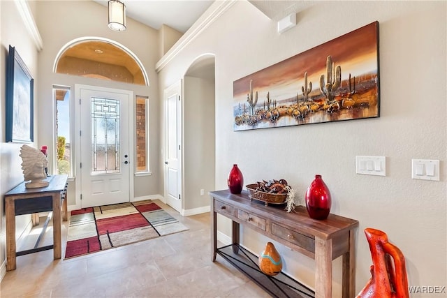 foyer entrance featuring light tile patterned flooring and baseboards