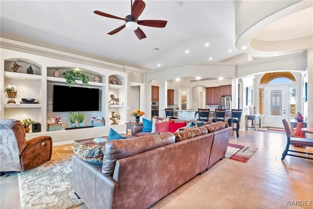 living room featuring built in features, a ceiling fan, and recessed lighting