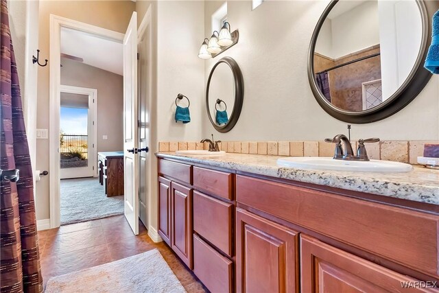 bathroom with a sink and double vanity