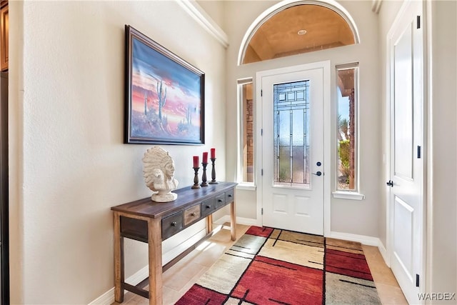 foyer entrance featuring light tile patterned floors and baseboards