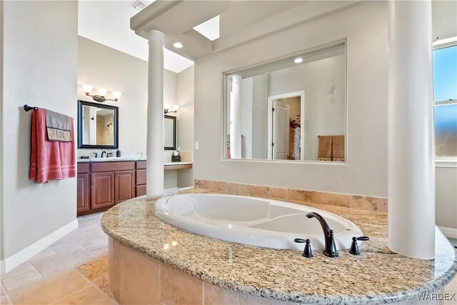 bathroom featuring decorative columns, visible vents, vanity, baseboards, and a bath