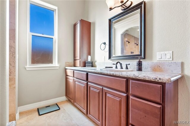 bathroom with vanity and baseboards