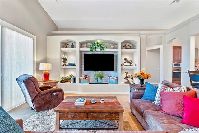 living area featuring visible vents and built in features