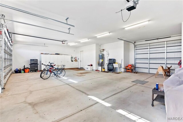 garage with a garage door opener and water heater