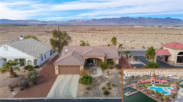 birds eye view of property featuring a mountain view and a desert view