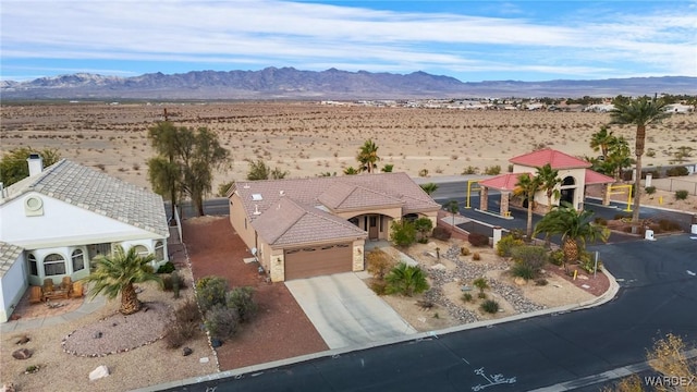 birds eye view of property featuring view of desert and a mountain view