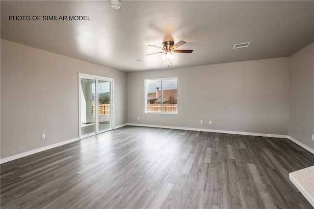 7567 E Cayuse Ct, Kingman, AZ 86401 - spare room with ceiling fan, dark wood finished floors, and baseboards