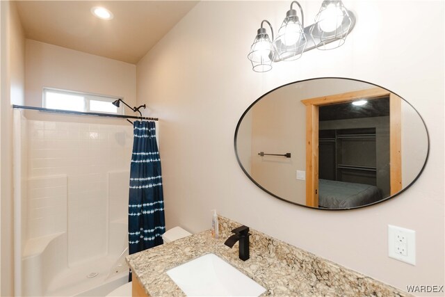 ensuite bathroom with a stall shower, ensuite bath, vanity, and recessed lighting