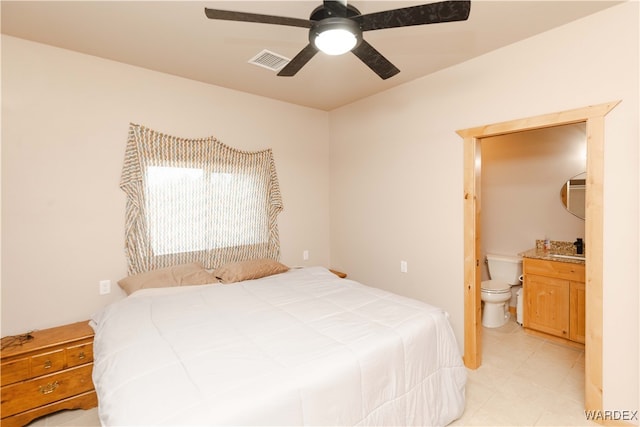 bedroom with ceiling fan, ensuite bath, and visible vents