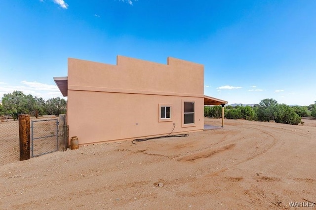 back of house featuring stucco siding