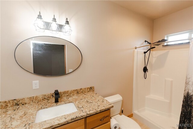 full bathroom with toilet, a shower stall, and vanity