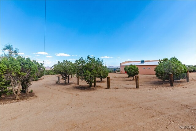 view of yard featuring driveway and a rural view