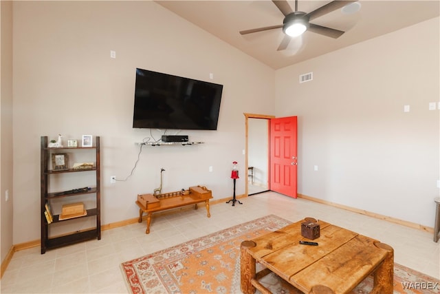 living room featuring ceiling fan, visible vents, vaulted ceiling, and baseboards