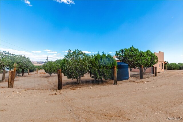 view of yard with a rural view and fence