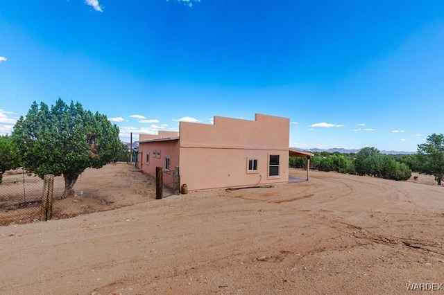 exterior space with fence and stucco siding