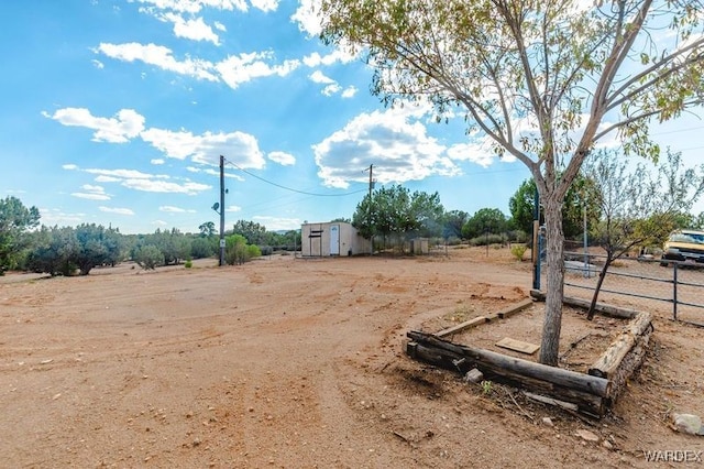 view of yard featuring fence and a rural view