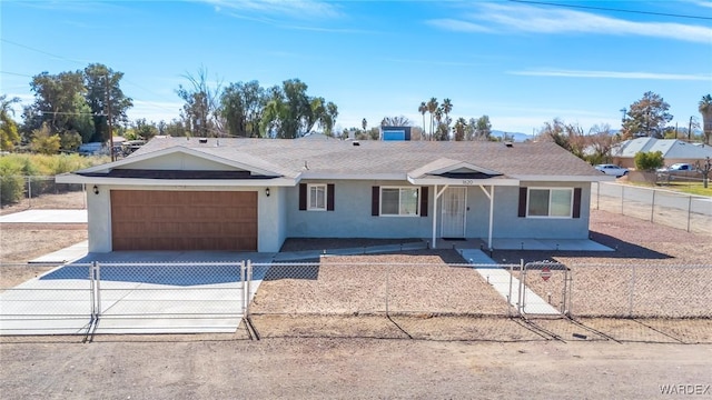 single story home featuring a garage, a fenced front yard, concrete driveway, and stucco siding