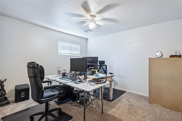 office area featuring baseboards, carpet flooring, visible vents, and a ceiling fan