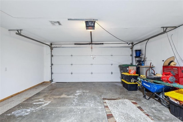 garage with baseboards, visible vents, and a garage door opener