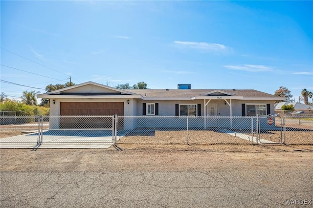 single story home featuring a garage, concrete driveway, a fenced front yard, and stucco siding