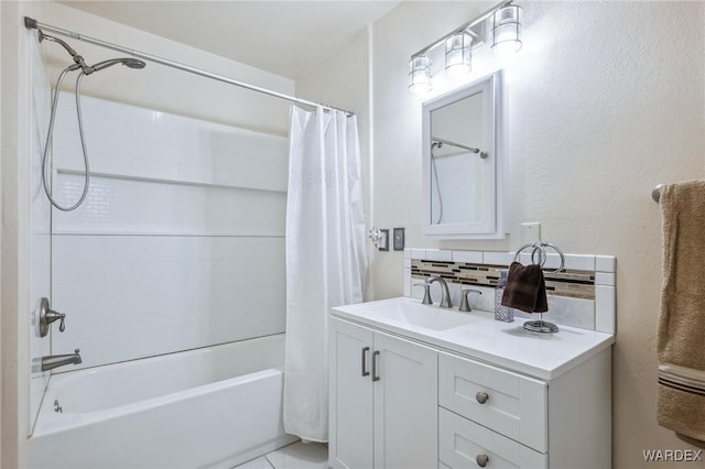 bathroom with tasteful backsplash, shower / bath combination with curtain, and vanity