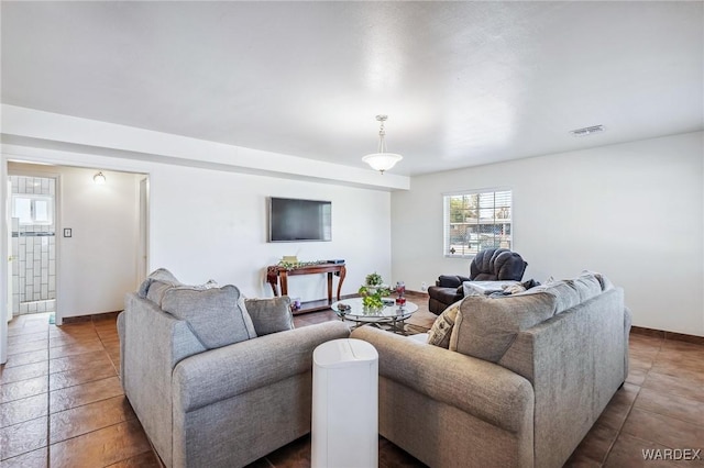 living area featuring tile patterned flooring and visible vents