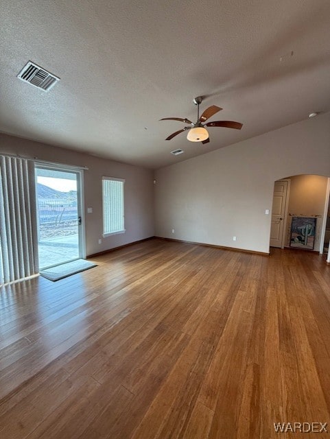 unfurnished living room with a textured ceiling, light wood-style flooring, and visible vents