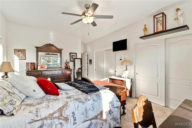 bedroom featuring light carpet and ceiling fan