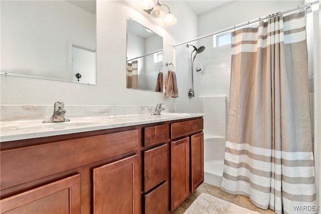 bathroom with a sink, a shower with shower curtain, and double vanity