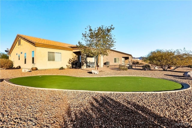 back of property featuring stucco siding