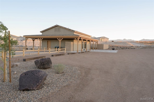 view of front of home with fence and a mountain view