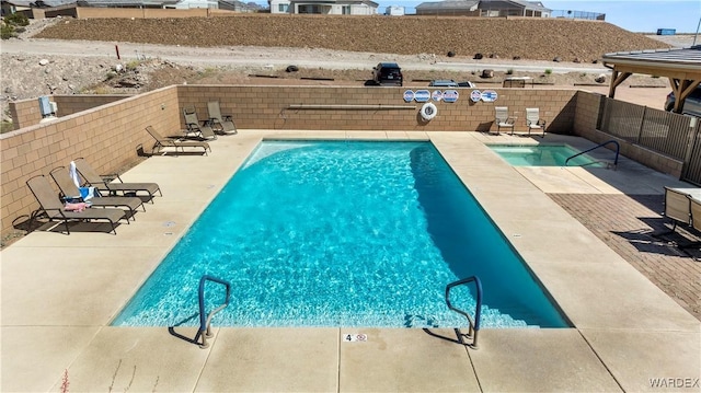 pool featuring a fenced backyard and a patio