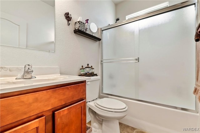 full bath with shower / bath combination with glass door, vanity, and toilet