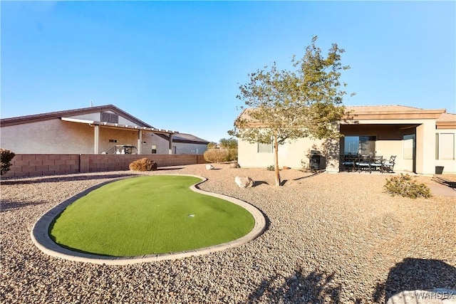 view of yard featuring fence and a patio