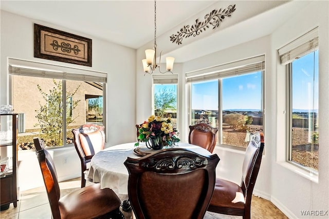 dining area with baseboards and a chandelier