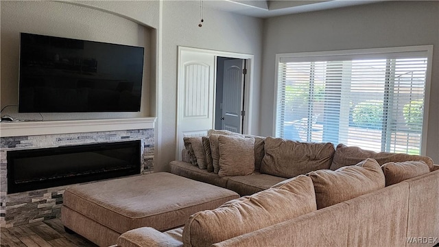 living room with a fireplace and wood finished floors