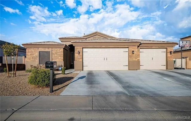 ranch-style house featuring an attached garage, stone siding, concrete driveway, and stucco siding