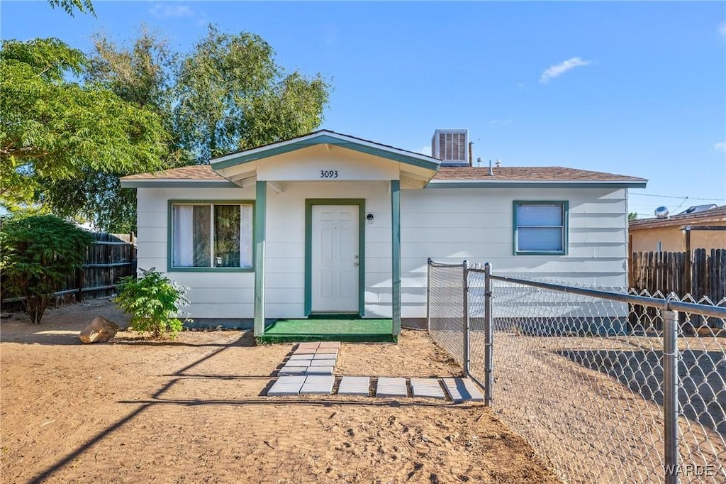 view of front of house with central AC and fence private yard