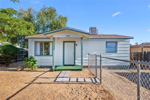 view of front of house with central AC and fence private yard