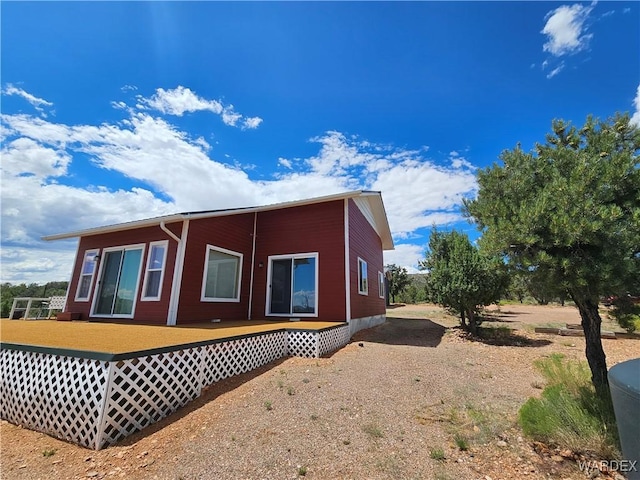 view of property exterior with a wooden deck