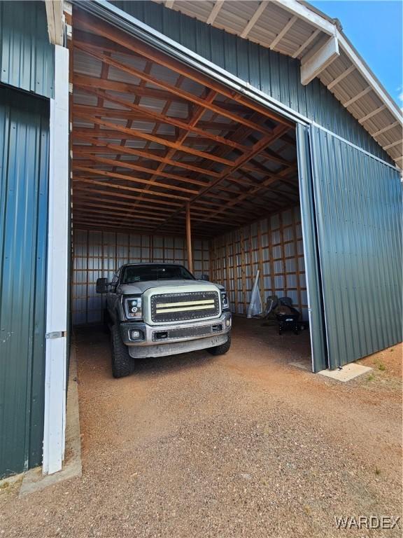 view of parking / parking lot with an outbuilding