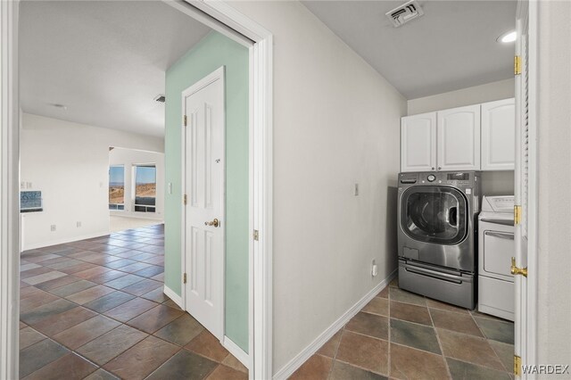 laundry area featuring cabinet space, baseboards, visible vents, and washer and dryer