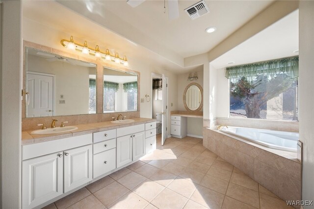 bathroom with tile patterned flooring, visible vents, ceiling fan, and a sink