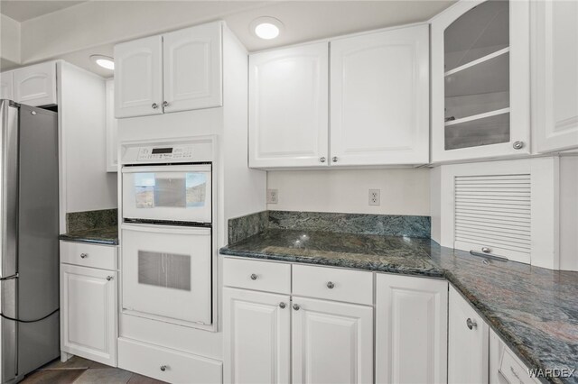 kitchen with white cabinets and freestanding refrigerator