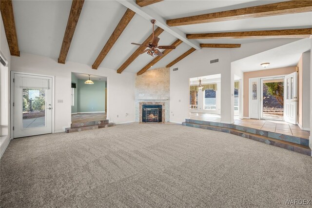 unfurnished living room with high vaulted ceiling, a tile fireplace, light carpet, visible vents, and beamed ceiling